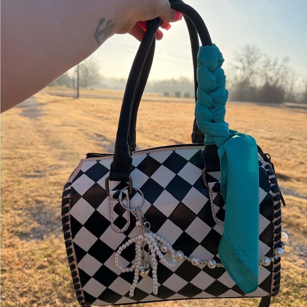 Stylish Black and White Checkered Handbag with Teal Accent